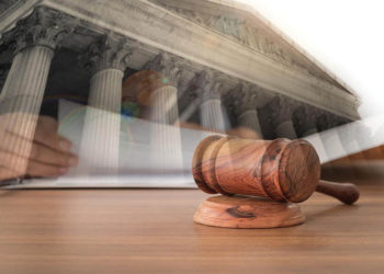 Gov. Stitt Named Among Defendants in Class Action Suit