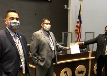MCN Principal Chief David Hill (Far Right) MCN National Council Speaker Randall Hicks (Center) and MCN Second Chief Dell Beaver are pictured holding a freshly affirmed “Independent Mvskoke (Creek) Press law on July 23. (Photo by Angel Ellis)