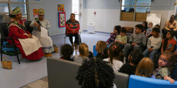 Mvskoke Royalty read to children at MCN Okmulgee Childcare