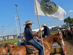 Bristow community chairwoman carries the Muscogee flag at rodeo